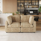 Khaki sofa in a living room setting with a piano and bookshelf in the background.